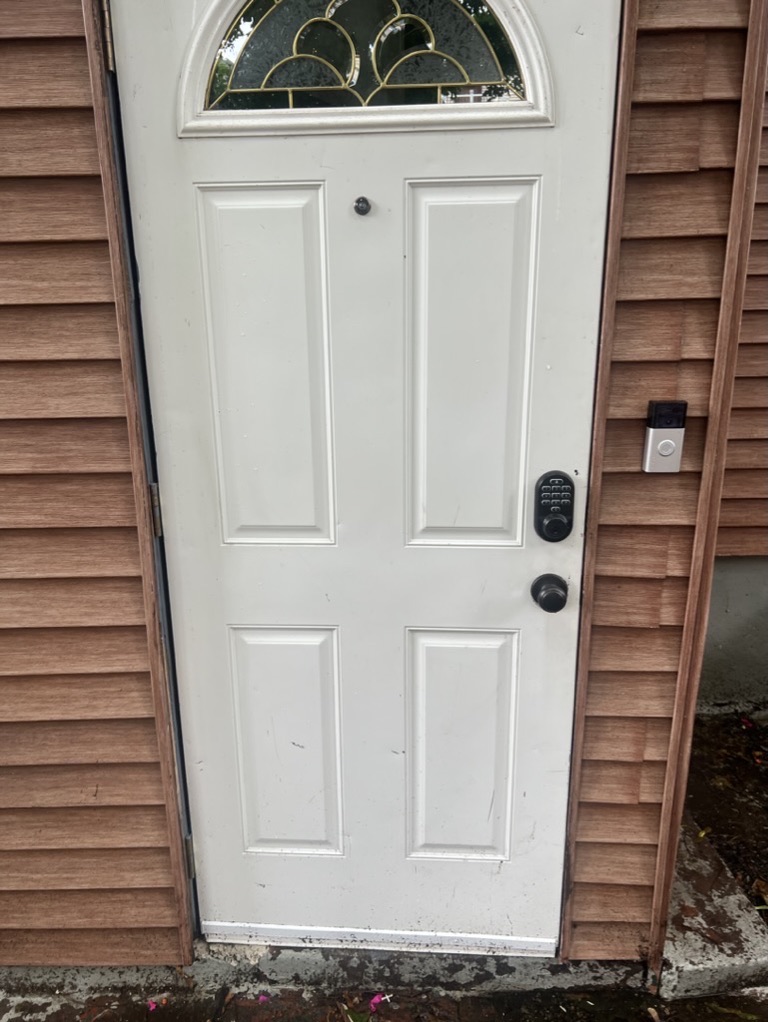 Related views of an exterior entry and adjacent wall finish