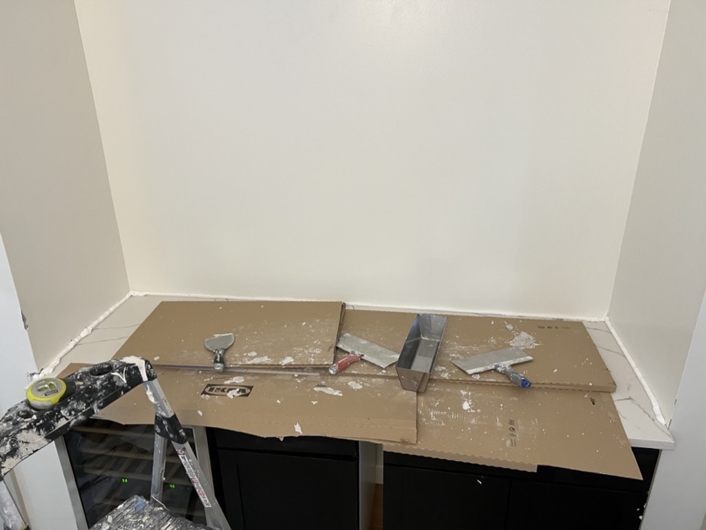 Related views of a countertop and adjacent wall finish area