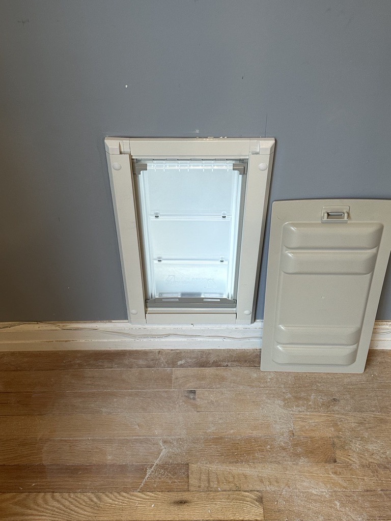 Related views of a pet door installed in an interior wall