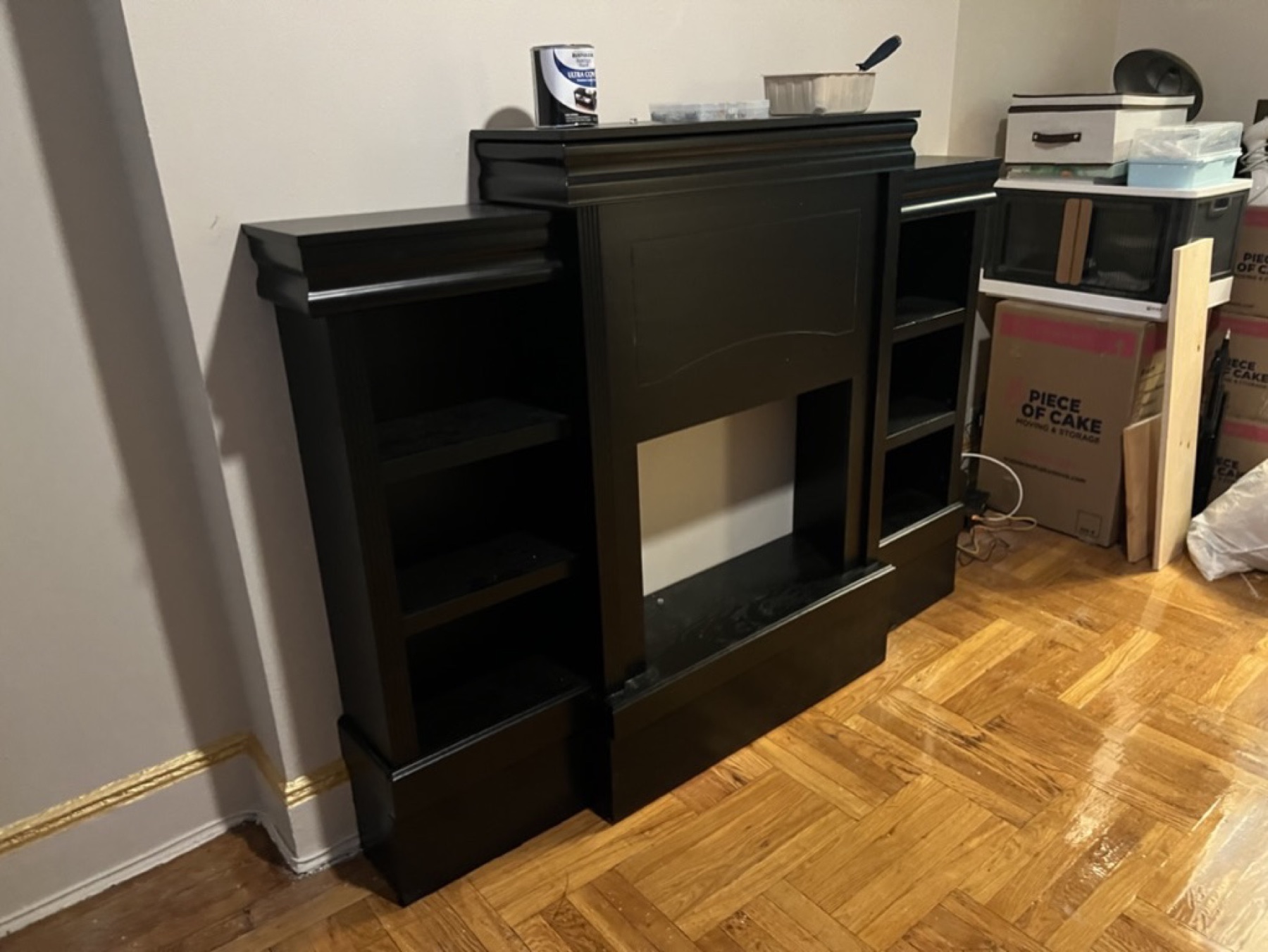 Wide finished view of fireplace cabinet raised on a matching base