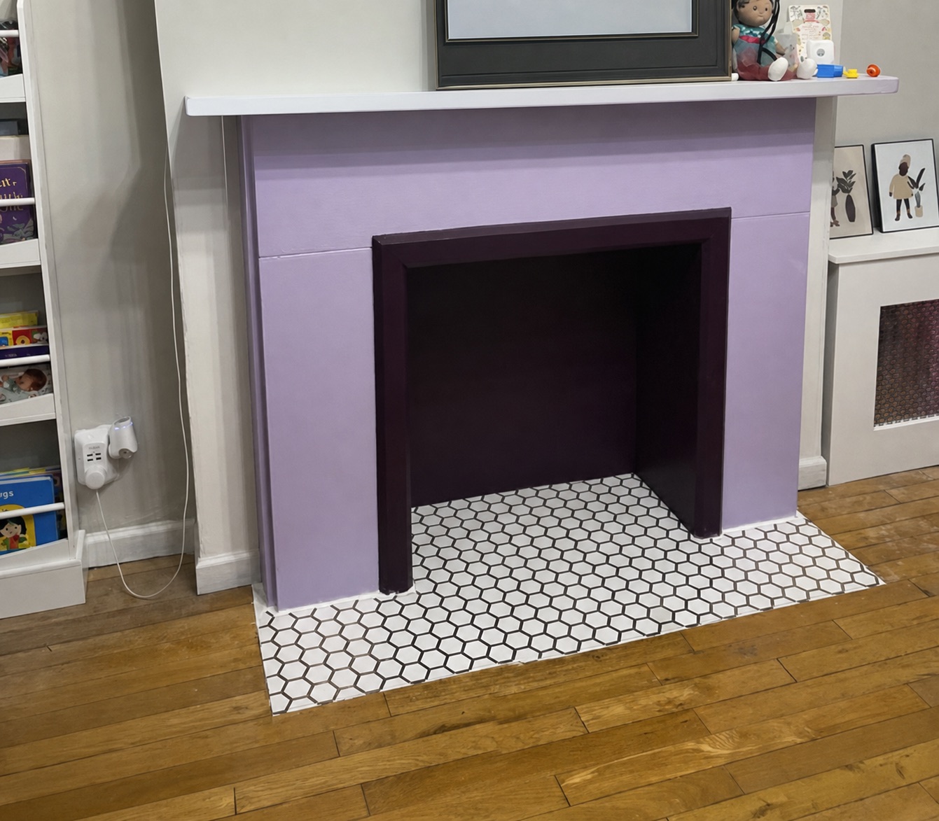 Finished hexagon tile floor and hearth around a fireplace surround