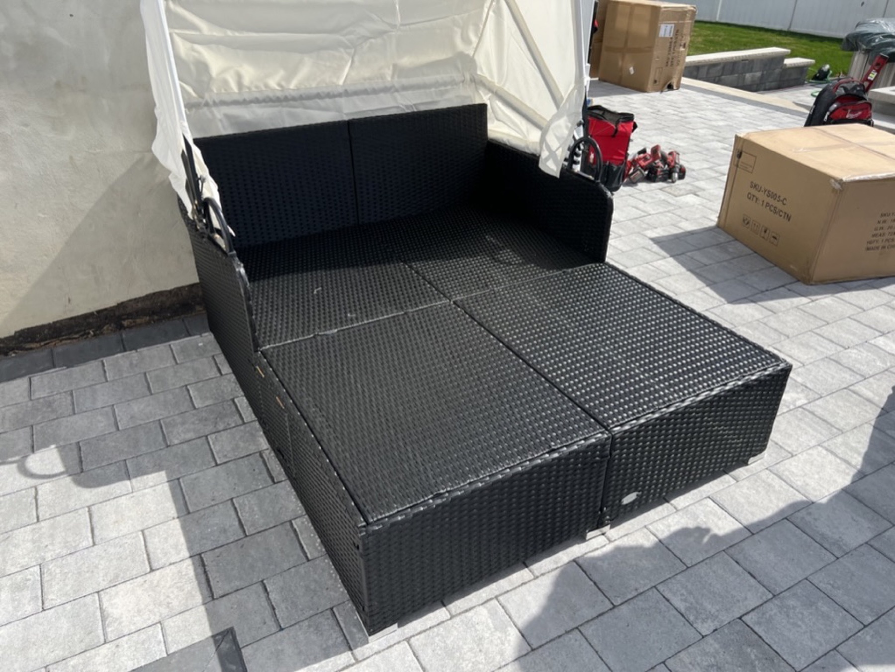 Outdoor canopy daybed frame and seating platform during assembly